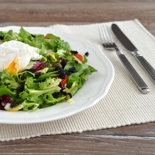 Salad with poached egg, caviar and chicory